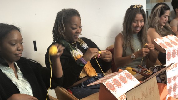 Sip N' Stitch — women crocheting together at a community event