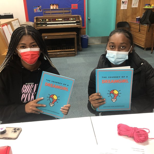 Two Dream Girls holding their Journey of a DreamGirl journals