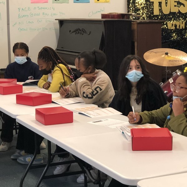 Dream Girls opening their red DreamGirl kits in class