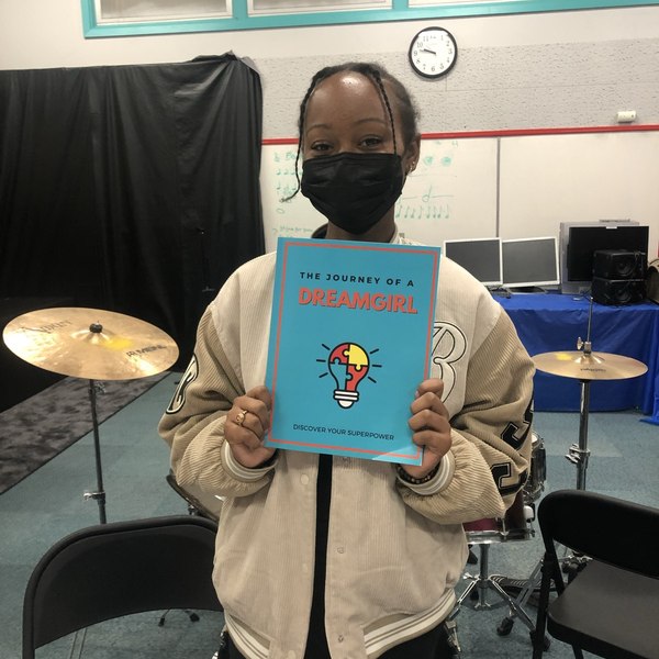 A Dream Girl holding her journal: Discover Your Superpower